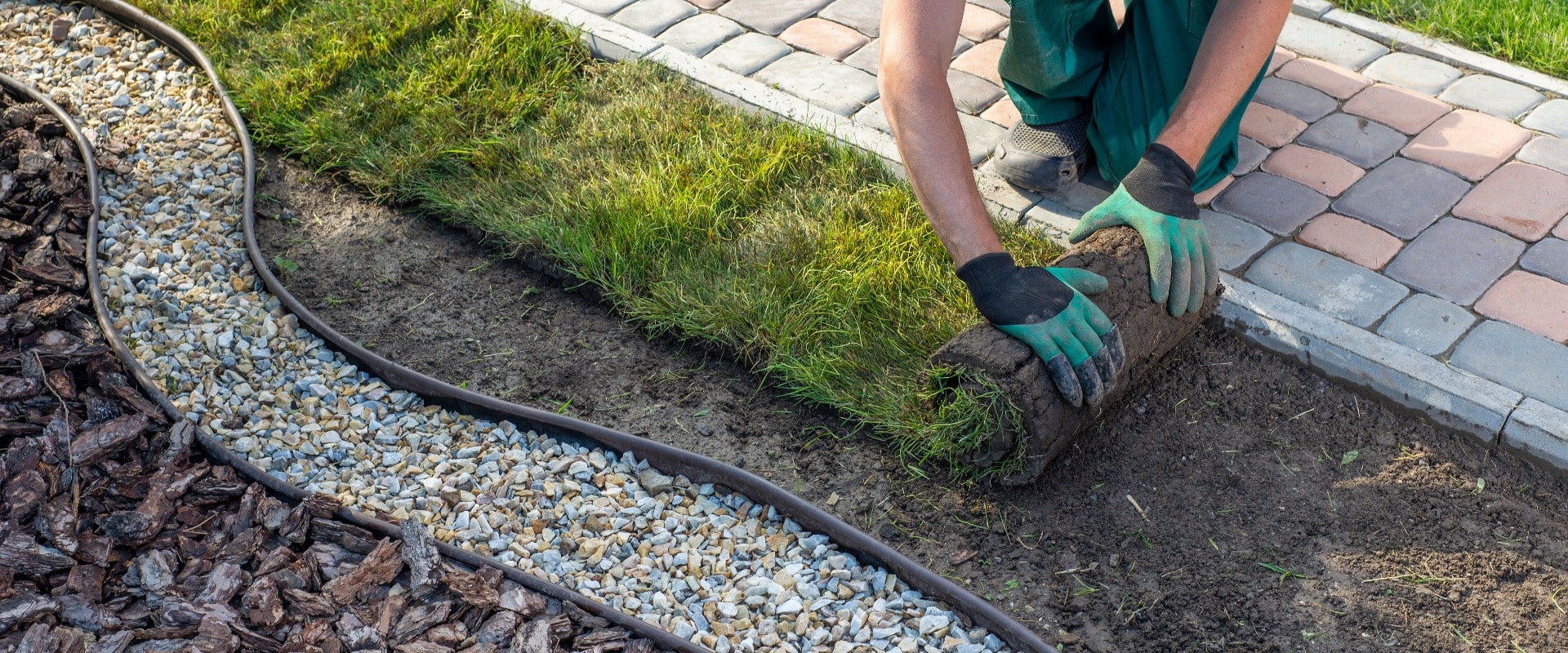 Landscape Gardener Laying Turf For New Lawn